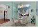 Charming dining area with glass table and four chairs, near kitchen at 1006 Sayle St, The Villages, FL 32162