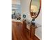 Bright entryway with hardwood floors and a glass-topped console table at 1006 Sayle St, The Villages, FL 32162