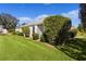 White house exterior with landscaped lawn and manicured hedges at 1006 Sayle St, The Villages, FL 32162
