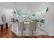 Bright kitchen with white cabinets, breakfast bar, and view to the dining area at 1006 Sayle St, The Villages, FL 32162