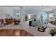 Open living room with light blue walls, hardwood floors, and access to lanai at 1006 Sayle St, The Villages, FL 32162