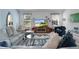 Living room featuring a large TV, comfy sofas, and a coffee table at 1006 Sayle St, The Villages, FL 32162