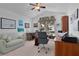 Home office with a desk, chair, sofa, and large window at 1006 Sayle St, The Villages, FL 32162