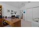 Bright home office with wood desk, chair, and printer at 1006 Sayle St, The Villages, FL 32162