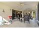 Screened porch features patio furniture and a grill at 1006 Sayle St, The Villages, FL 32162