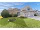 Two-story house with a two-car garage and landscaped yard at 1102 Ivawood Way, The Villages, FL 32163