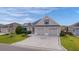 Two-story house with a two-car garage and landscaped yard at 1102 Ivawood Way, The Villages, FL 32163