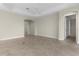 Large living room with tile floors and access to other rooms at 1102 Ivawood Way, The Villages, FL 32163