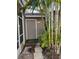 Private backyard with storage shed and tropical plants at 12144 Bruceton Way # 101, Orlando, FL 32828