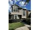 Two-story house with gray siding, large windows, and well-manicured landscaping at 12144 Bruceton Way # 101, Orlando, FL 32828