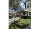 Landscaped front yard with a white picket fence and a small tree at 12144 Bruceton Way # 101, Orlando, FL 32828