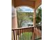 View from balcony overlooking a lake and surrounding trees at 13584 Turtle Marsh Loop # 132, Orlando, FL 32837