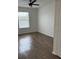 Spacious bedroom featuring wood-look flooring and a large window at 13584 Turtle Marsh Loop # 132, Orlando, FL 32837