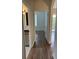Light and bright hallway with wood-look flooring, leading to bedrooms and bathroom at 13584 Turtle Marsh Loop # 132, Orlando, FL 32837