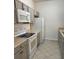 Modern kitchen with gray cabinets, stainless steel appliances, and tile flooring at 13584 Turtle Marsh Loop # 132, Orlando, FL 32837