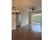 Spacious living room with wood-look flooring and access to balcony at 13584 Turtle Marsh Loop # 132, Orlando, FL 32837