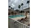 Community pool with lounge chairs and a covered patio area at 13584 Turtle Marsh Loop # 132, Orlando, FL 32837