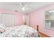 Pastel pink bedroom with double bed and ceiling fan at 1612 Staunton St, The Villages, FL 32162