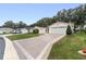Two-car garage and neatly landscaped yard with driveway at 1612 Staunton St, The Villages, FL 32162