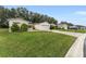House exterior showcasing a two car garage and spacious front yard at 1612 Staunton St, The Villages, FL 32162