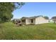 Features a large backyard with a view of neighboring homes at 1612 Staunton St, The Villages, FL 32162