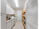 Laundry room with washer, dryer, and extra shelving at 1612 Staunton St, The Villages, FL 32162