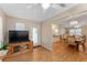 Living room with wood floors and view to dining area at 1612 Staunton St, The Villages, FL 32162