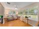 Living area featuring a comfy sofa and large windows at 1612 Staunton St, The Villages, FL 32162