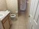 Clean bathroom with toilet, vanity, and door to exterior at 1964 Banning Beach Rd, Tavares, FL 32778