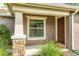 Front door entry with window and stone accents at 30529 Lipizzan Ter, Mount Dora, FL 32757