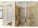 Bathroom with a large shower stall, grab bars, and tiled walls at 30529 Lipizzan Ter, Mount Dora, FL 32757