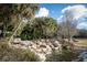 Serene waterfall feature with lush landscaping and pond at 30529 Lipizzan Ter, Mount Dora, FL 32757