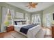 Spacious bedroom with king-size bed and access to backyard at 3530 Mulberry Grove Loop, Leesburg, FL 34748