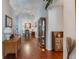 Bright and spacious entryway with hardwood floors and views into the dining area at 4130 Capland Ave, Clermont, FL 34711
