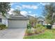 One-story house with a two-car garage and landscaped yard at 4130 Capland Ave, Clermont, FL 34711