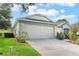 One-story house with a two-car garage and well-maintained lawn at 4130 Capland Ave, Clermont, FL 34711