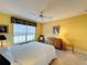 Bedroom with a queen bed and dresser, featuring a large window at 4634 Summerbridge Cir, Leesburg, FL 34748
