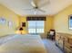 King-size bed in a sunny bedroom with wood dresser at 4634 Summerbridge Cir, Leesburg, FL 34748