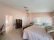 Primary bedroom with king bed, access to bathroom, and walk-in closet at 4634 Summerbridge Cir, Leesburg, FL 34748