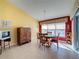 Bright dining area with wood table and chairs, and a view to the lanai at 4634 Summerbridge Cir, Leesburg, FL 34748