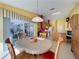 Dining area with table and chairs, view of kitchen and lanai at 4634 Summerbridge Cir, Leesburg, FL 34748