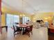 Dining room with a wooden table, chairs, and access to the lanai at 4634 Summerbridge Cir, Leesburg, FL 34748