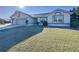 Single story home with attached garage and a lush green lawn at 4634 Summerbridge Cir, Leesburg, FL 34748