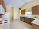 Bright kitchen with wood cabinets, stainless steel appliances, and tile flooring at 4634 Summerbridge Cir, Leesburg, FL 34748