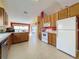 Bright kitchen with lots of wood cabinets and stainless steel appliances at 4634 Summerbridge Cir, Leesburg, FL 34748