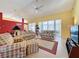 Living room with vaulted ceilings, tiled floors, and sliding doors to the lanai at 4634 Summerbridge Cir, Leesburg, FL 34748