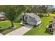 Single-story house with driveway and a green lawn at 5533 Grove Mnr, Lady Lake, FL 32159