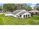 Single-story home with landscaped yard at 5533 Grove Mnr, Lady Lake, FL 32159