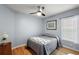 Cozy bedroom with wood floors and ceiling fan at 5533 Grove Mnr, Lady Lake, FL 32159