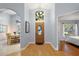 Bright and spacious entryway with wood floors and views to other rooms at 5533 Grove Mnr, Lady Lake, FL 32159